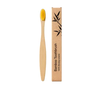 Yellow flat head bamboo toothbrush with tapered bristles for gentle and effective daily cleaning.